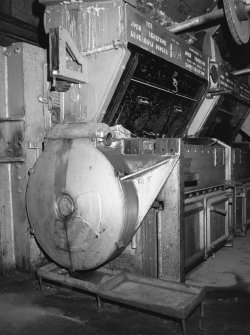 Interior.
View of end cover of automatic chain-grate stoker on boiler front.