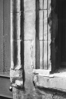 Detail of central doorway rybats, bolection moulded surround and remains of window sill.