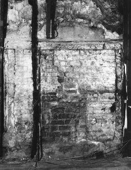 Interior.
View of remains of bolection moulded fireplace on E wall of ground floor apartment.