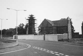 View of house and Old Parish Church under scaffolding.
