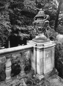 View of terrace balustrade topped by decorative urn.