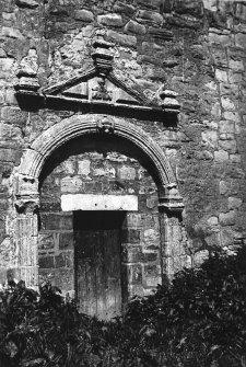 View of doorway with pediment and archway.