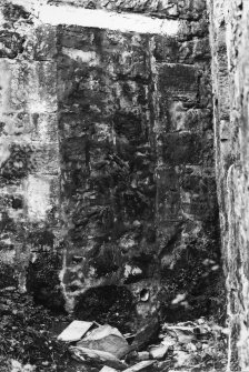 Detail of blocked doorway and inscribed lintel on N wall.