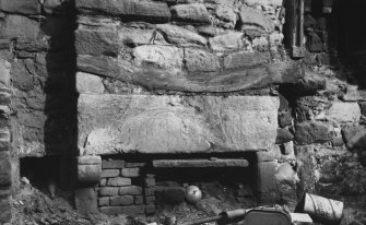 Detail of fireplace and beam in exposed SW wall.