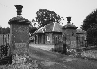 View of gate piers and lodge house from SW.