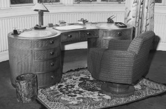 Interior.
Ground floor, sitting room, detail of desk, chair and litter bin.