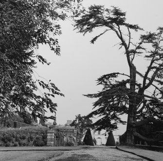 General view of garden with terraces and distant view of house.