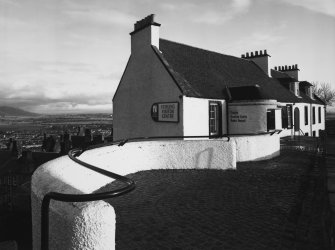 General view from NNW with curved walls in foreground.