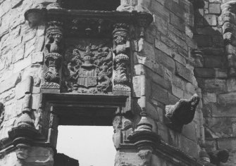 View of heraldic panel to left of entrance.