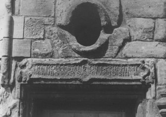 Detail of inscription on right of entrance.