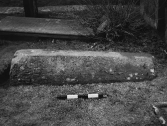 View from side of coped grave marker.