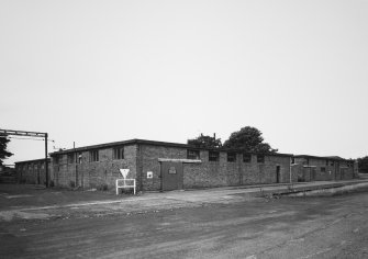 General view from S of block containing general stores and joiners' and mechanics' workshop.