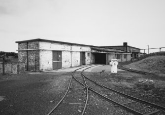 View from N of railway dispatch buildings [V1, V2 and V9] also showing typical example of electrical switchgear box and narrow gauge railway connecting most parts of the factory.