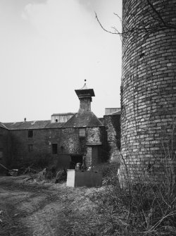 View from ESE of former kiln in centre of main block of farm buildings, with base of brick chimney stack (foreground right).