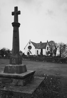 General view from E with cross shaped war monument in foreground.