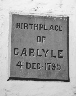 Detail of plaque commemorating birth of Thomas Carlyle on NE elevation.
