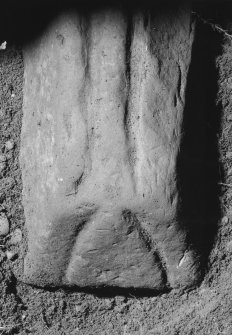 Detail of end of coped graveslab to SE of church bearing two parallel graves in its upper surface.