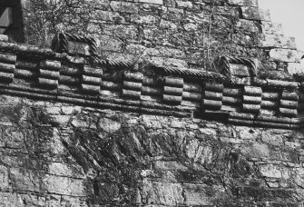 Detail of parapet corbel course along SE wall and relieving arch below.