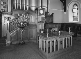 Detail of Communion table and pulpit with organ behind.