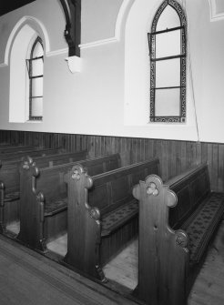 Detail of rows of pews.