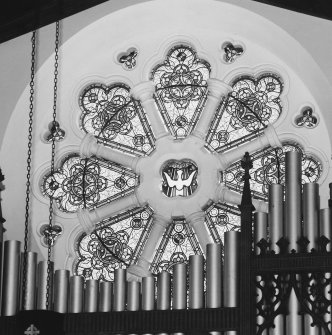 Detail of E rose window with organ in front.