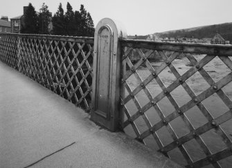 Detail of latticed steel railings of bridge.