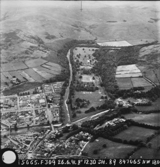 RAF WWII oblique aerial photograph of Langholm Barracks taken from the SE.  Part of Langholm town is also visible in the left foreground.