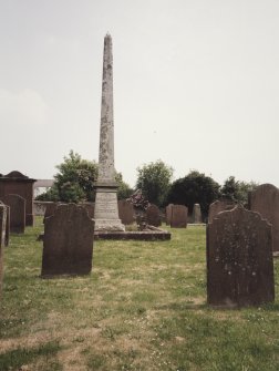 View of obelisk in churchyard from W.