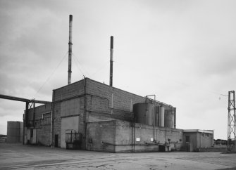 View from NW of Compressor House, and 3 external oil tanks