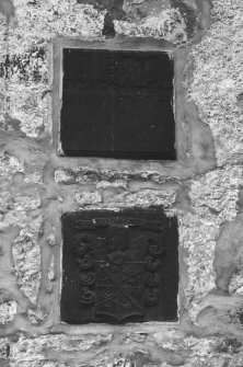 Detail of armourial panel and date stone on NW elevation.