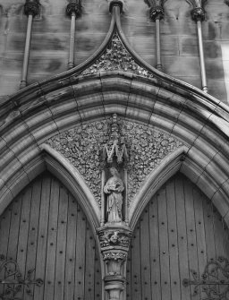 Detail. Entrance door spandrel with female saint