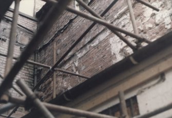 Detail of brickwork behind scaffolding.