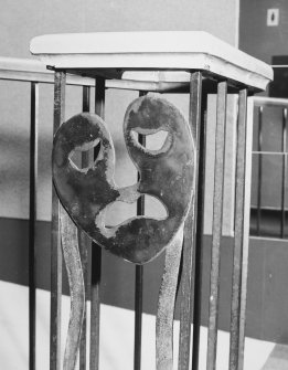 Interior. Foyer, detail of mask (tragedy) on handrail