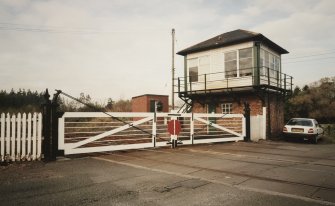 View of signal box from SW, with level crossing gates open to road traffic.