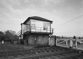 View of signal box from W, with level crossing gates open to road traffic.