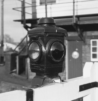 Detail of lamp at centre of level crossing gates (one on each of the two pairs of gates).