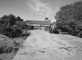 View from E showing part of the slipway with boathouse/sawmill with observation tower.