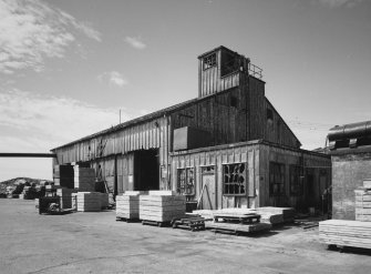 View from NE showing sawmill/boathouse with observation tower and asbestos cladding.