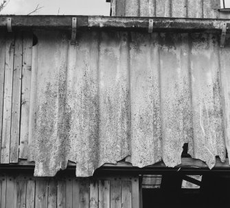 Detail of asbestos wall cladding on boathouse.