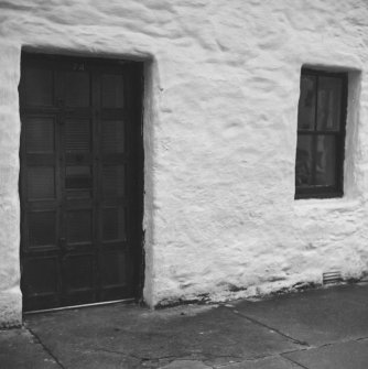 Detail of main entrance doorway and ground floor window from NE.