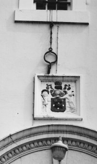 Detail of jougs and heraldic plaque over N elevation doorway.