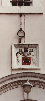 Detail of jougs and heraldic plaque over N elevation doorway.