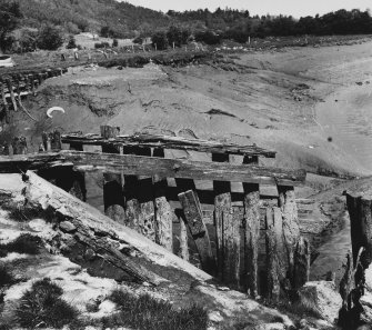 View of ruins of basin revetment at S side of entrance.