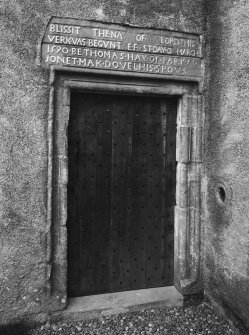 Detail of door with inscription above.