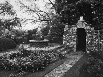 View of E garden gate and ornamental seat.