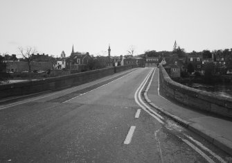 General view from E of E end of bridge, showing deck and splayed sandstone parapets.