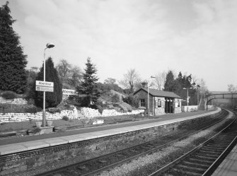 View from SW of N-bound platform, including waiting room and shelter, and station garden