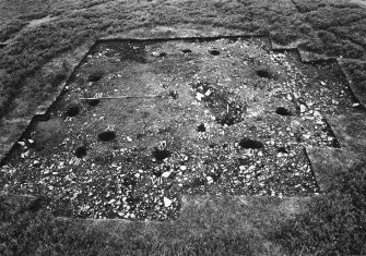 View of excavation showing the whole site with numbered postholes with stones removed