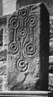 General view of cross-shaft showing carvings on front of stone.