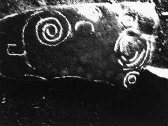 Views of spiral incised stone, in reuse as threshhold.